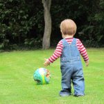 1.5 year old boy plays ball